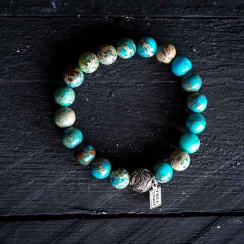 Kralen armband zee sediment licht turkoois met tibetaans geluks balletje