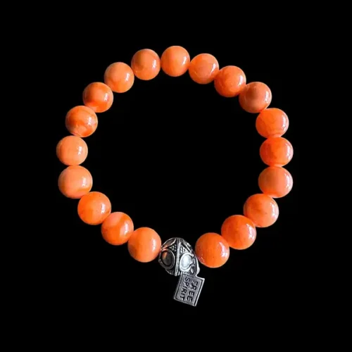 Kralen armband oranje Jade met tibitaans geluksballetje