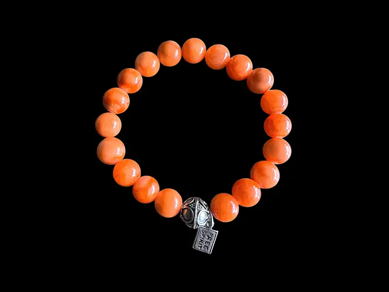 Kralen armband oranje Jade met tibitaans geluksballetje 1 Kralen armband oranje Jade met tibitaans geluksballetje
